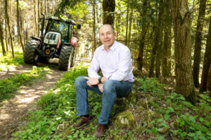 LT Präs. Max Hiegelsberger im Wald mit Traktor